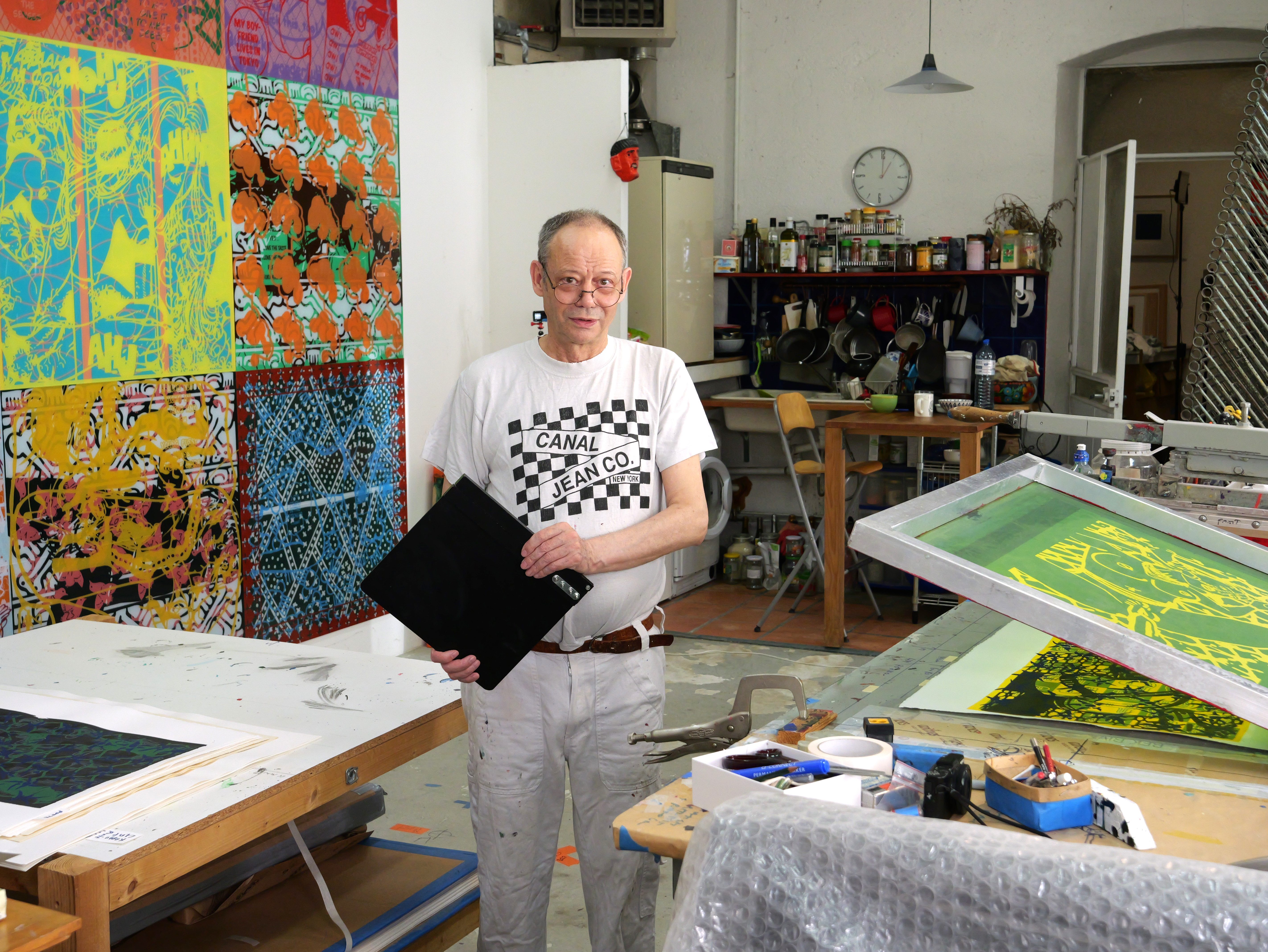 Artist working in his studio #10, silk-screening his images, photo by Lionel Georges, July 30th 2024.